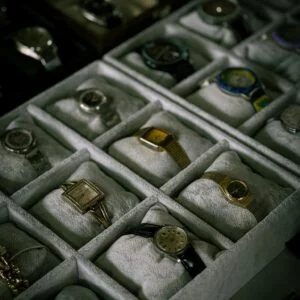 A curated collection of luxury watches displayed in neatly arranged boxes.