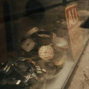 Discover a collection of vintage watches in an antique store window, evoking a retro feel.