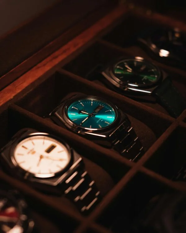 Showcase of elegant luxury watches in a display case with warm lighting.